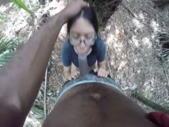 A nerdy Asian wife sips cum after having a bbc in the park.